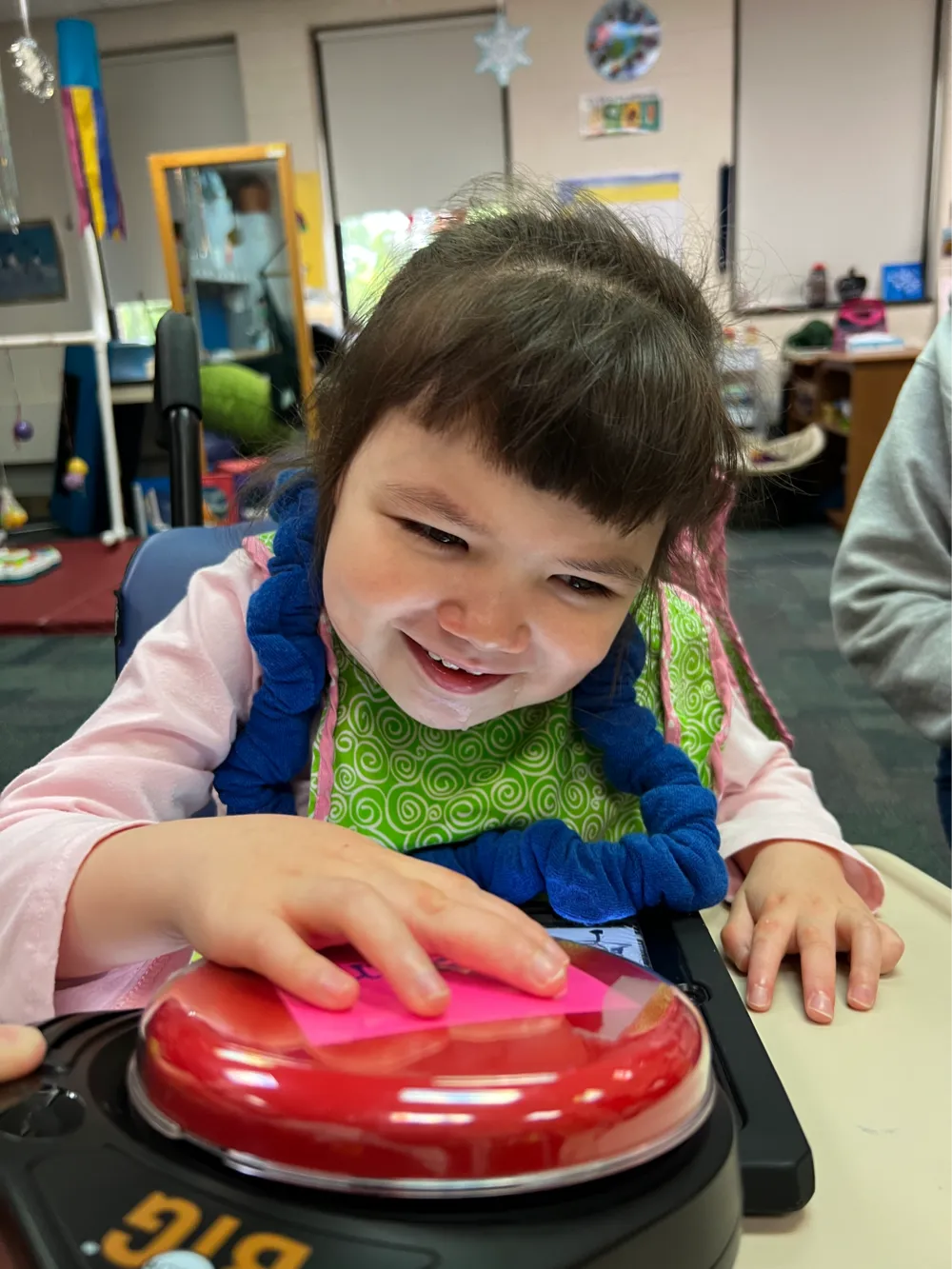 Gemma smiling with her hand on a large red switch